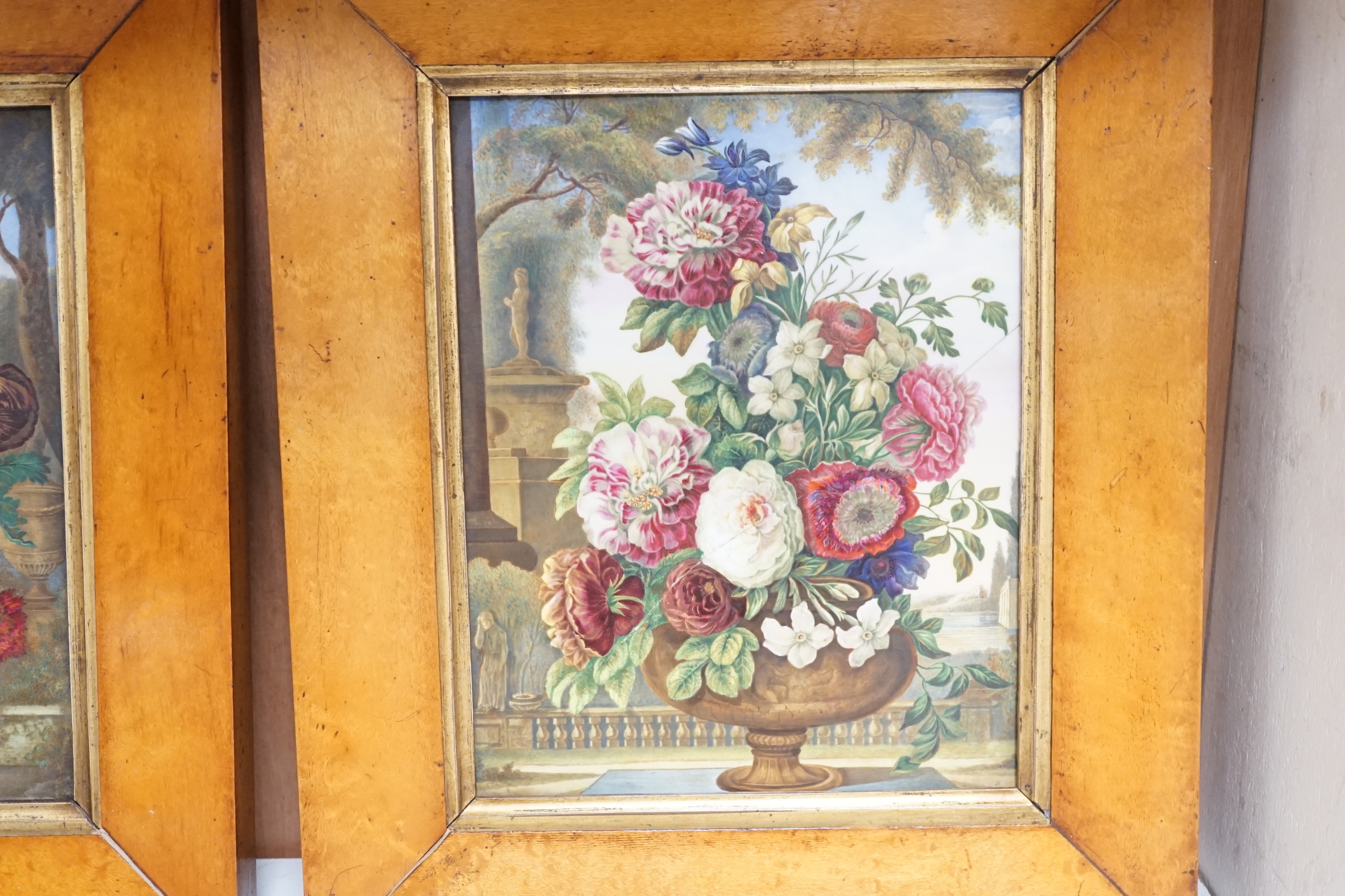 A pair of large English porcelain plaques, painted with flowers in urns, c.1830, maple framed (one cracked), 23cm x 18cm excluding frames